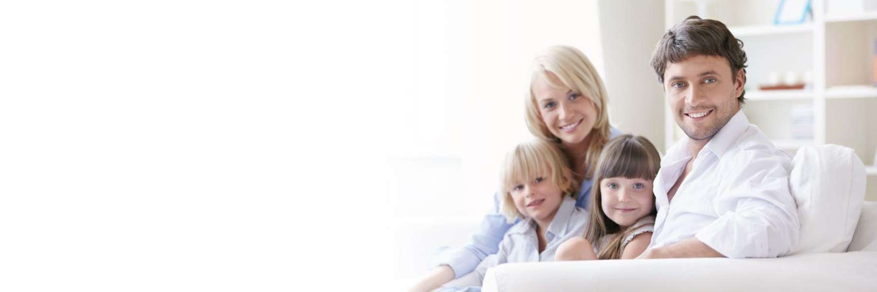 A smiling family on the couch | dentist Tamworth
