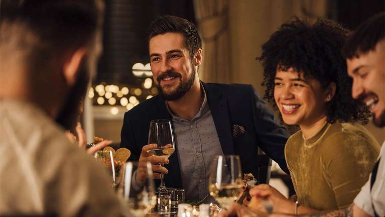 A group of friends at dinner | tooth whitening Tamworth