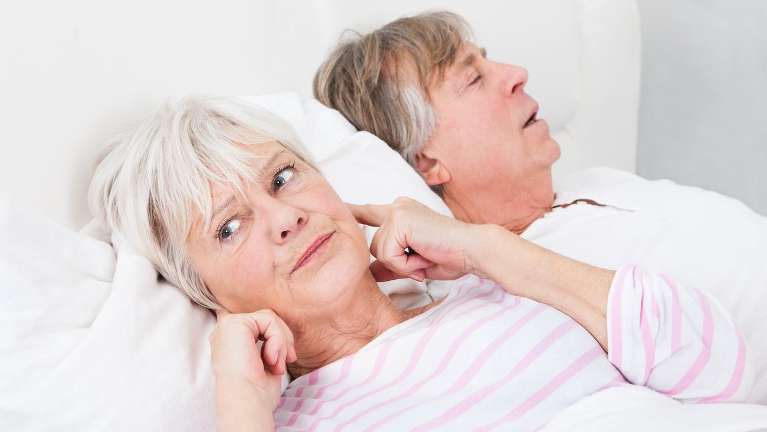 n older couple sleeps soundly, highlighting the value of good sleep and when to seek help.