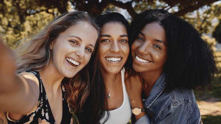 Three women smiling confidently after cosmetic dental care in Tamworth