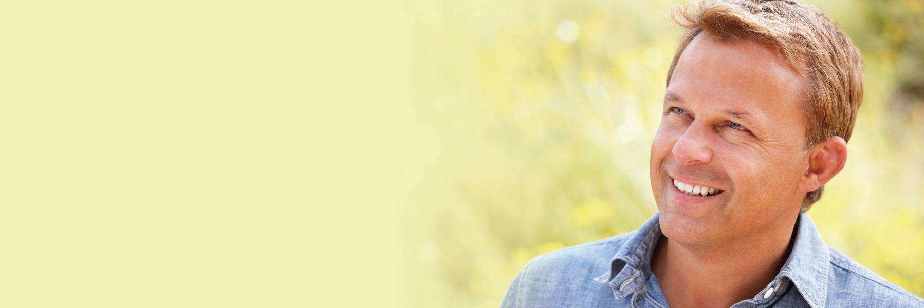 Smiling man outdoors | dentist near manilla